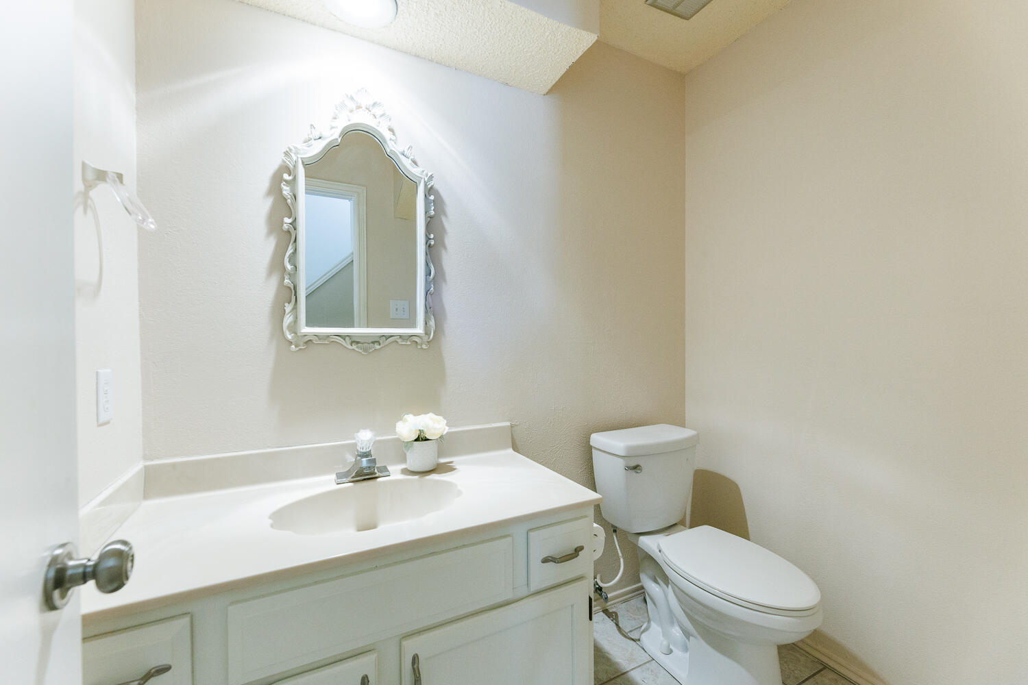 3316 79th Street Lubbock, TX 79423 - Photo 38 of 45 a bathroom with a toilet a sink and mirror