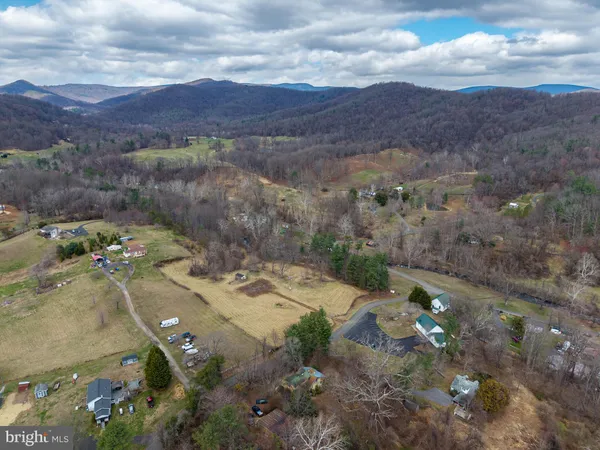 a view of a yard with wooden fence