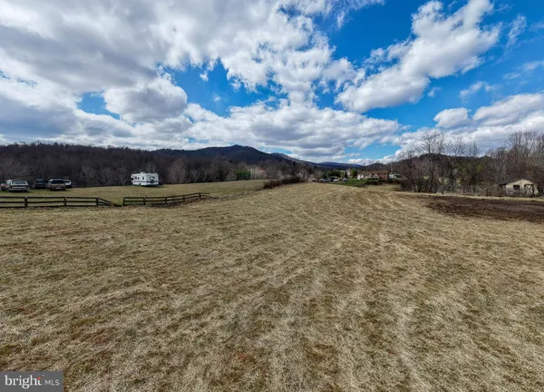 a view of a field with trees in the background