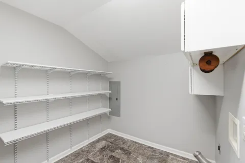 a view of storage and utility room with racks on the wall