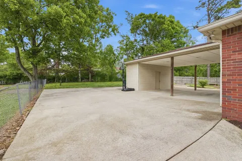 a view of a backyard with large tree