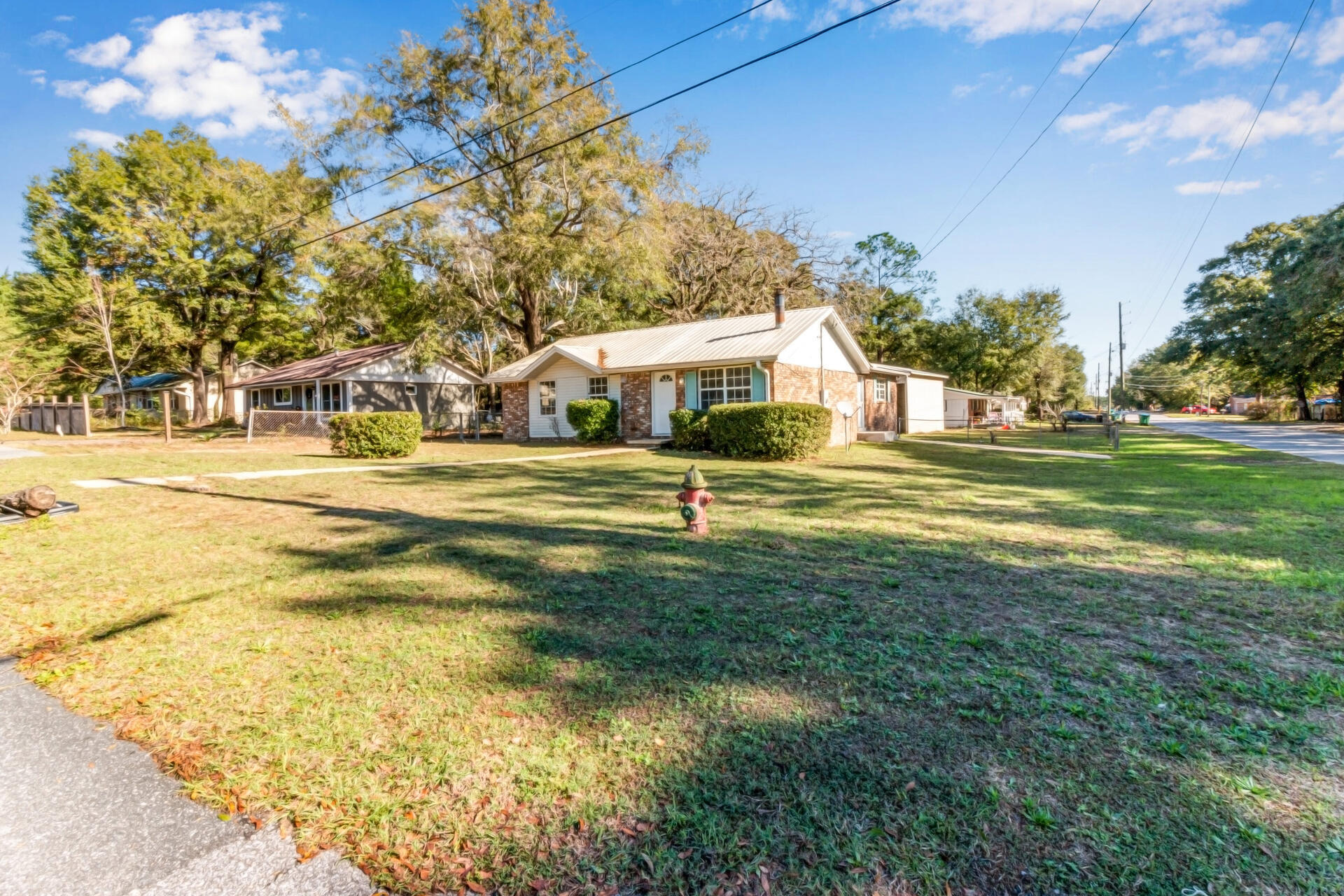 697 Long Drive Crestview, FL 32539 - Photo 1 of 26 a front view of a building with a garden