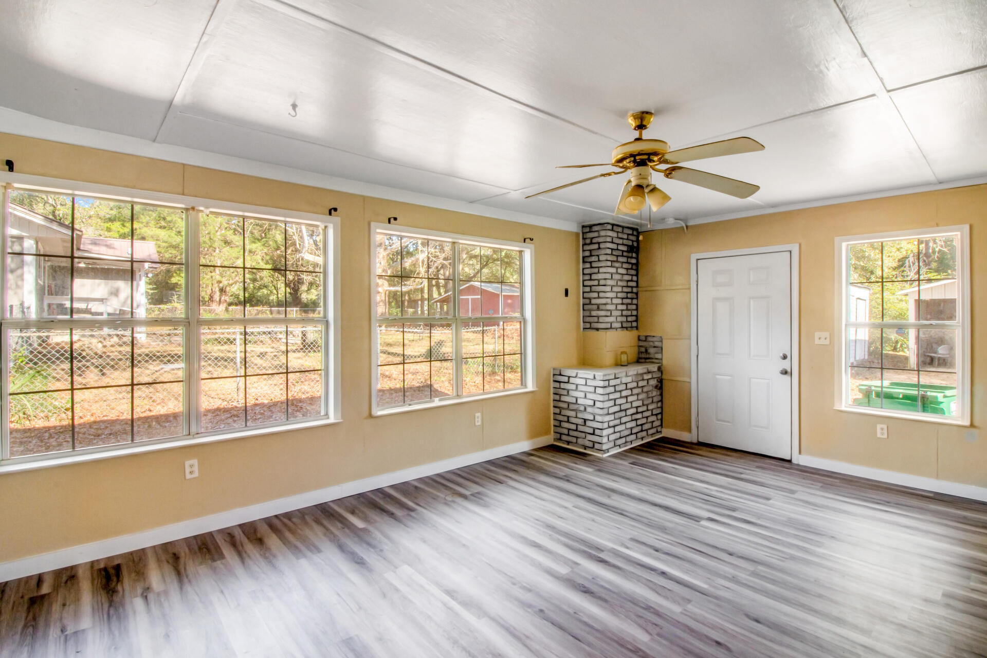 697 Long Drive Crestview, FL 32539 - Photo 14 of 26 a view of an empty room with a window and wooden floor