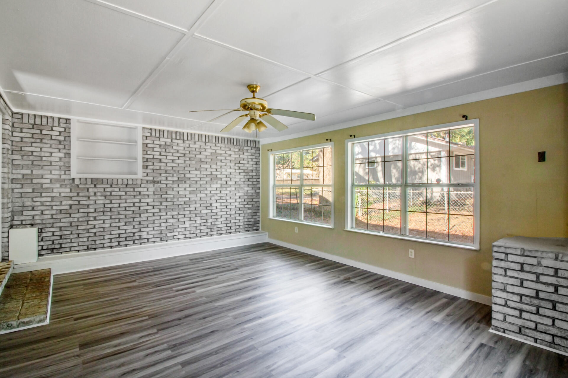 697 Long Drive Crestview, FL 32539 - Photo 15 of 26 a view of an empty room with wooden floor and a window