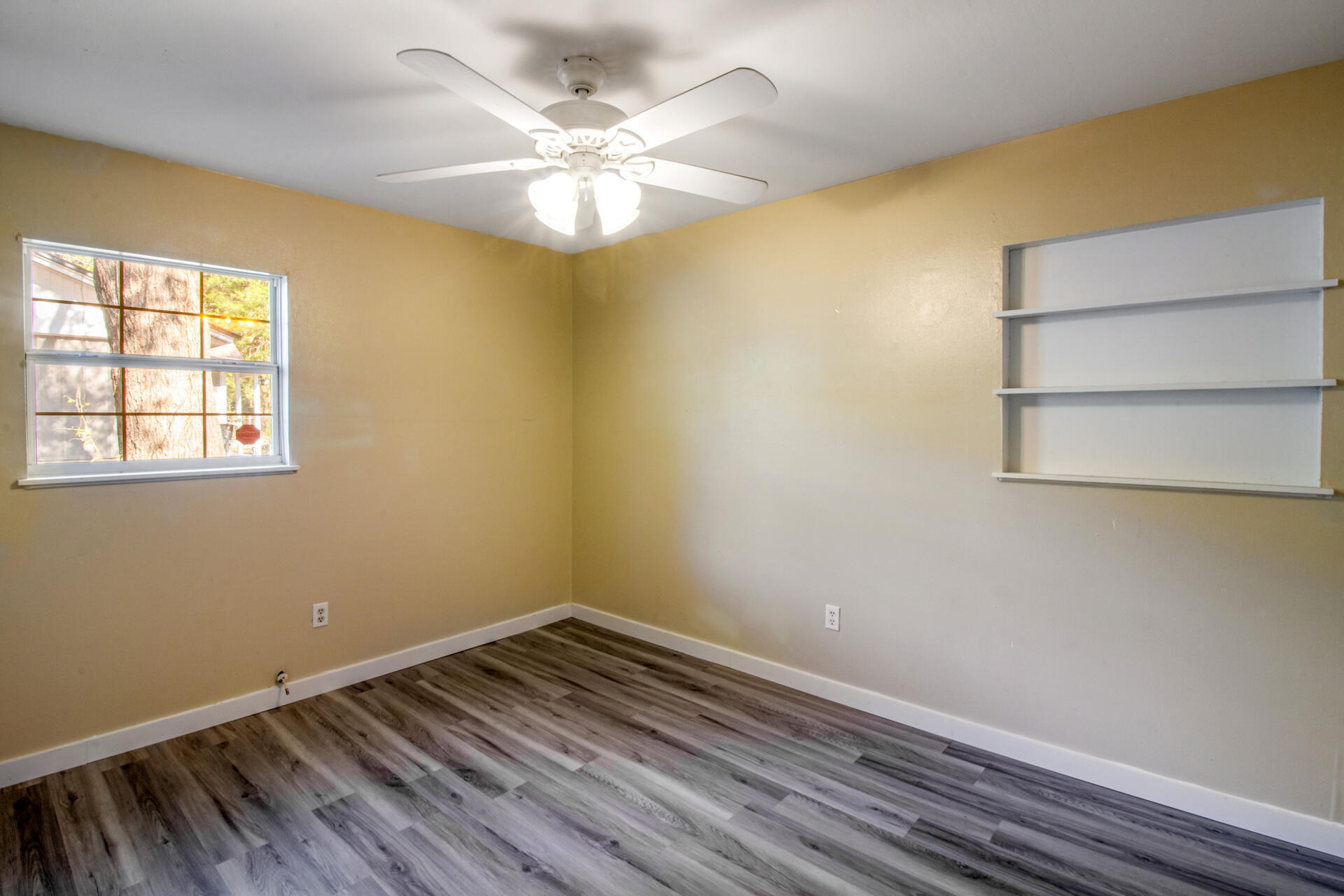 697 Long Drive Crestview, FL 32539 - Photo 19 of 26 a view of room with window and wooden floor