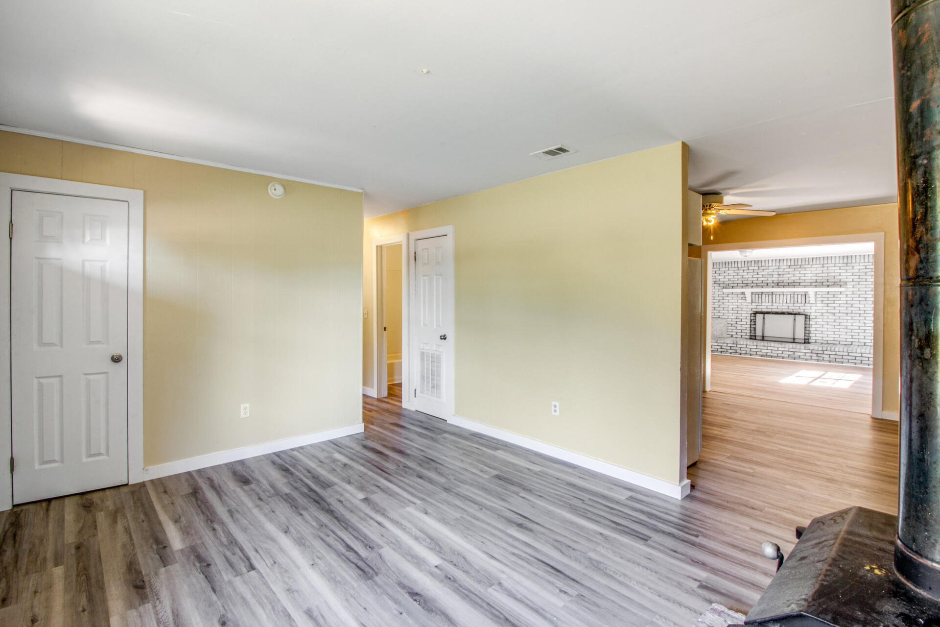 697 Long Drive Crestview, FL 32539 - Photo 6 of 26 a view of an empty room with wooden floor and a window