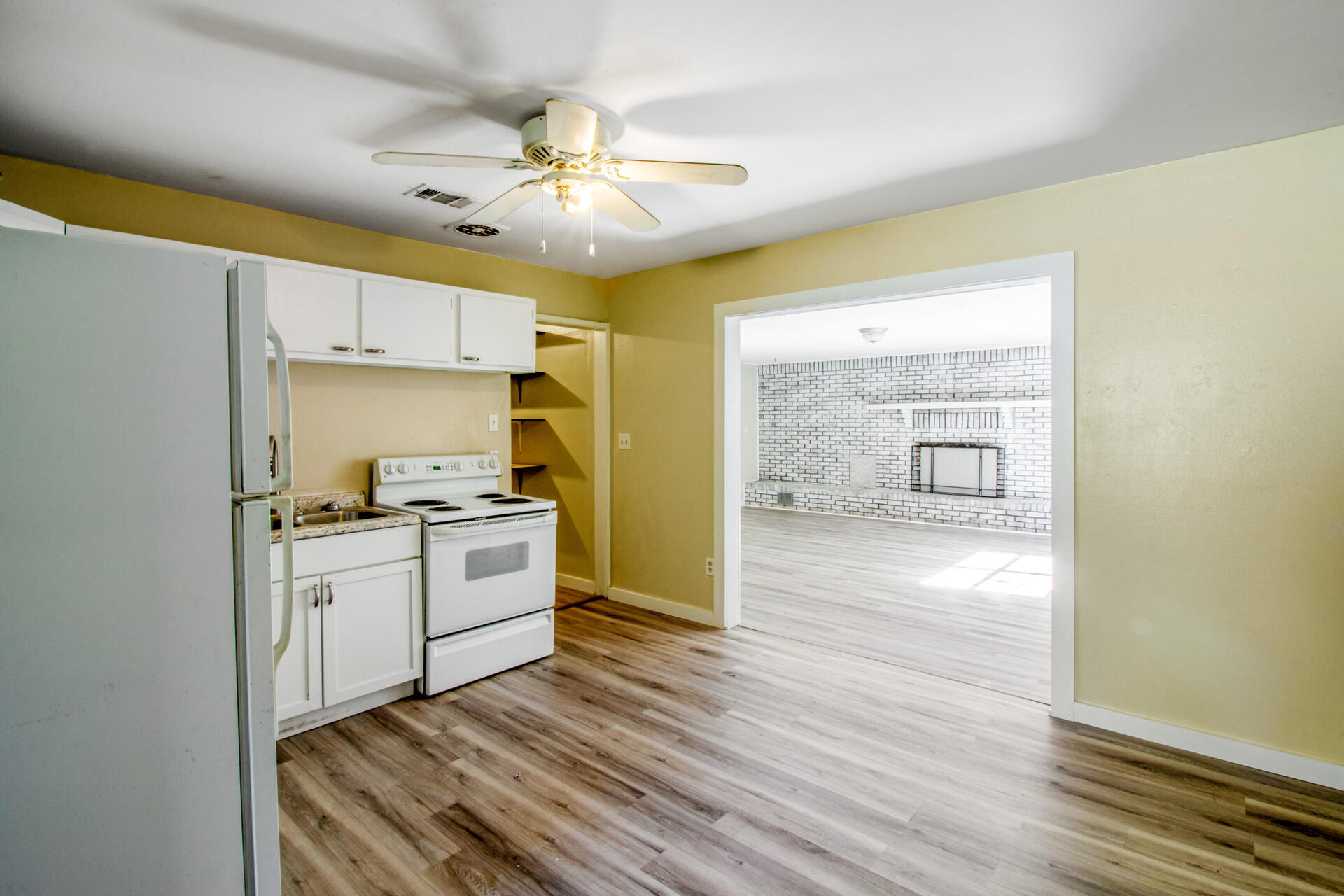 697 Long Drive Crestview, FL 32539 - Photo 8 of 26 a kitchen with a stove cabinets and wooden floor
