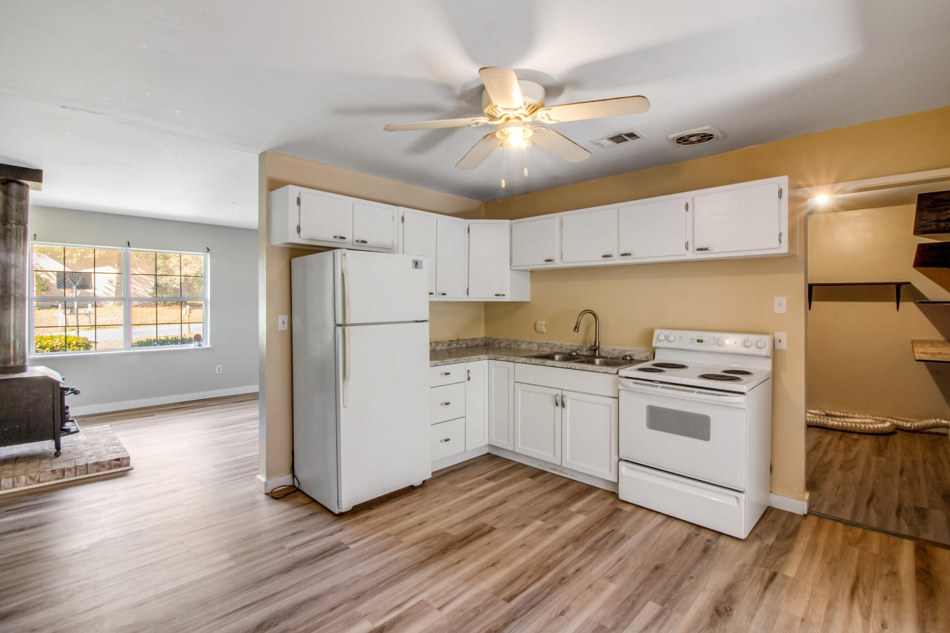 697 Long Drive Crestview, FL 32539 - Photo 9 of 26 a kitchen with a refrigerator and a stove top oven