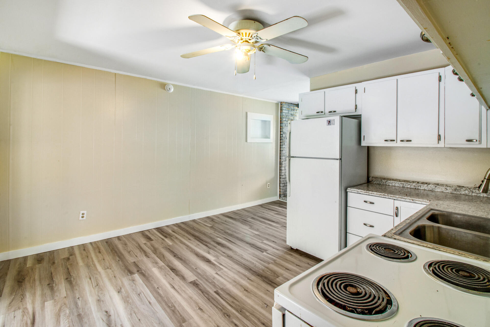 697 Long Drive Crestview, FL 32539 - Photo 10 of 26 a kitchen with a refrigerator and a stove top oven