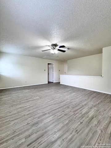 an empty room with a empty space and windows