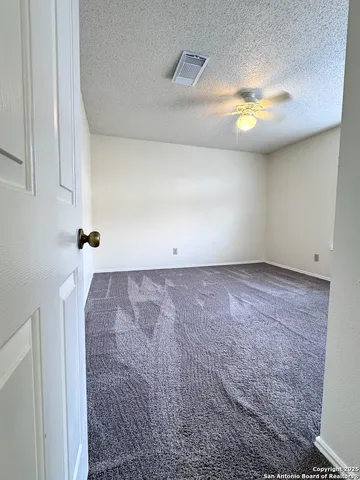 an empty room with a empty space and windows