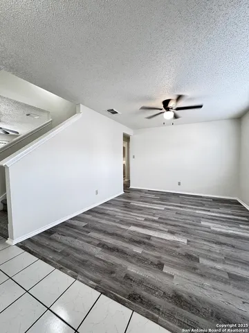 a view of a livingroom with a dishwasher and cabinets