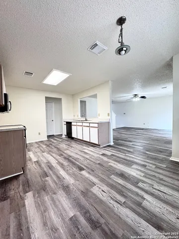 a view of kitchen and empty room