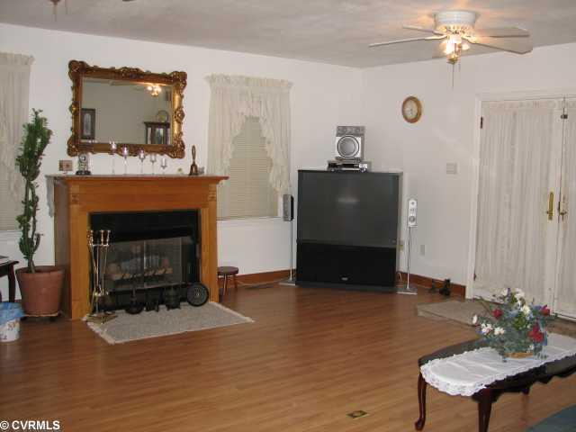 2108 Old Bermuda Hundred Road Chester, VA 23836 - Photo 3 of 4 Den/Family/Great Room - Large Great room with free-standing gas fireplace, laminate floors and French doors to deck