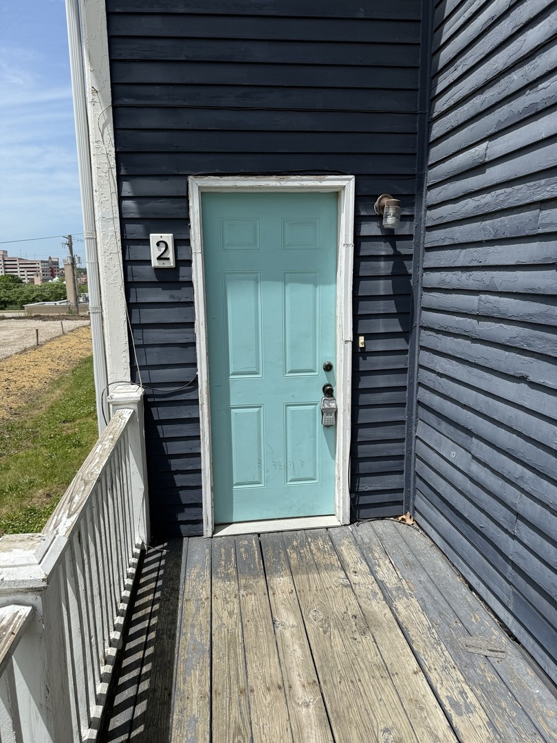 86 North 4th Street, Unit 2 Aurora, IL 60505 - Photo 2 of 6 a view of wooden balcony