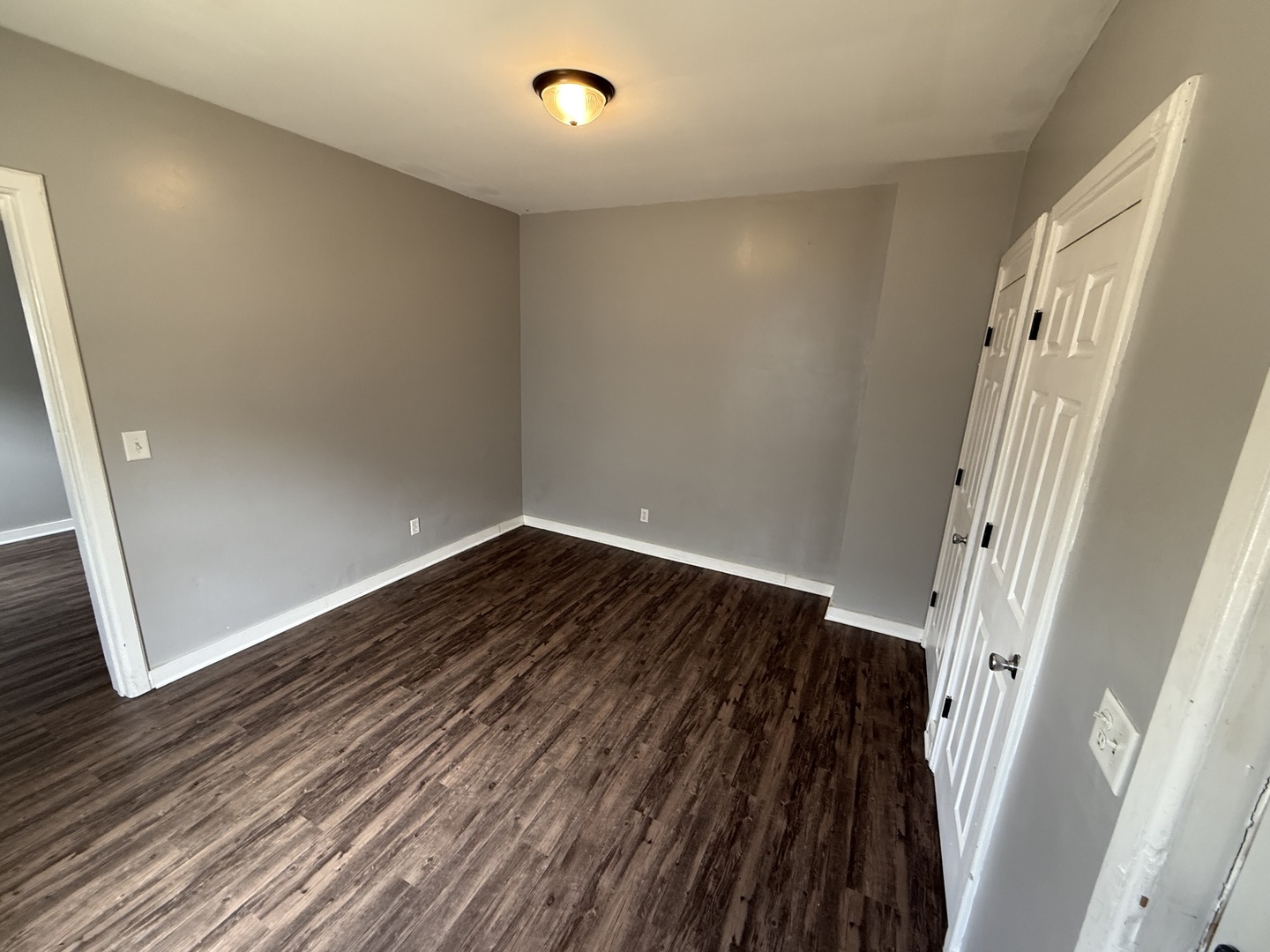 86 North 4th Street, Unit 2 Aurora, IL 60505 - Photo 3 of 6 an empty room with wooden floor and entrance