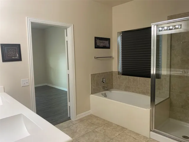 a bathroom with a bathtub and a shower