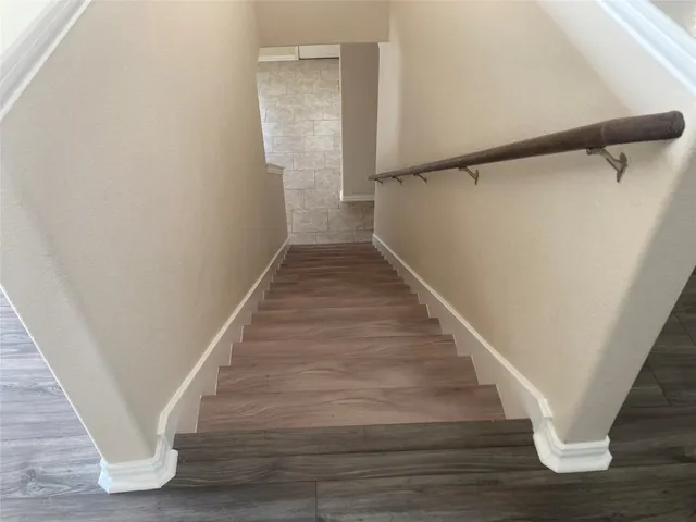 wooden floor in an empty room with a mirror