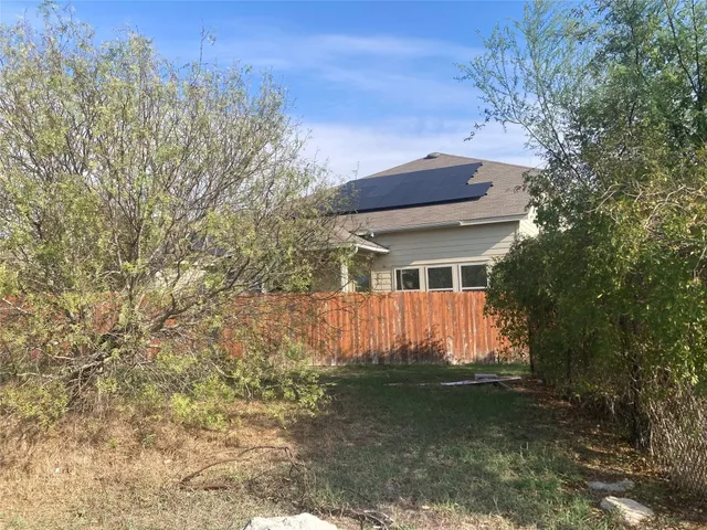 a view of a house with a backyard