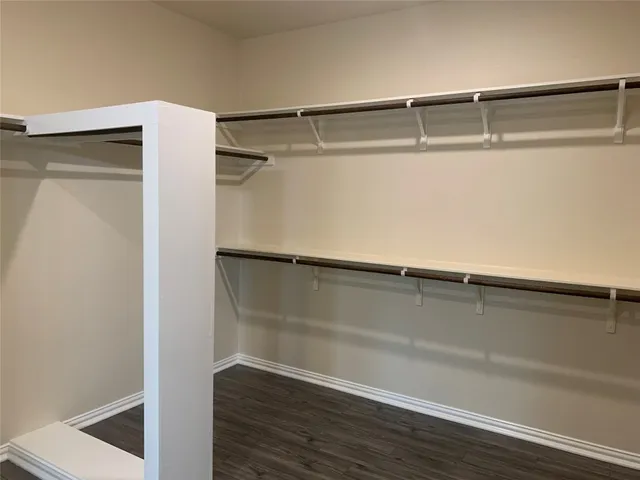 a view of a hallway with windows and chandelier