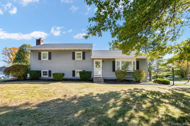a view of a house with a yard and sitting area