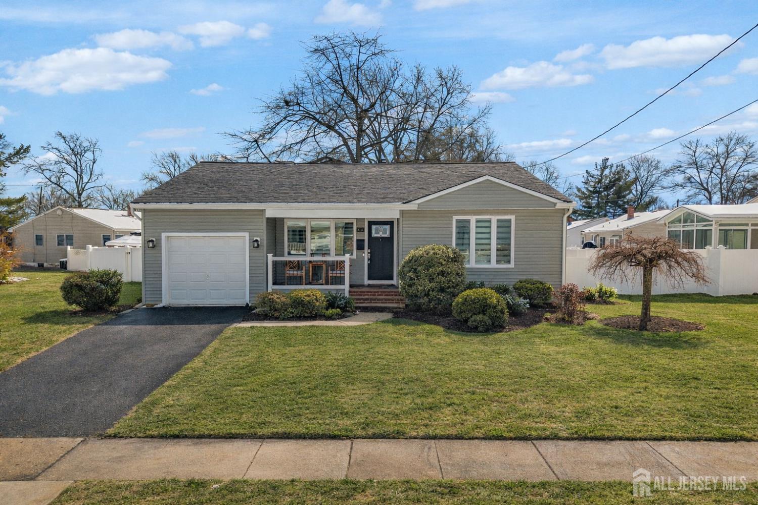 88 Wooding Avenue Edison, NJ 08817 - Photo 1 of 1 a view of a yard in front of a house with plants and large tree