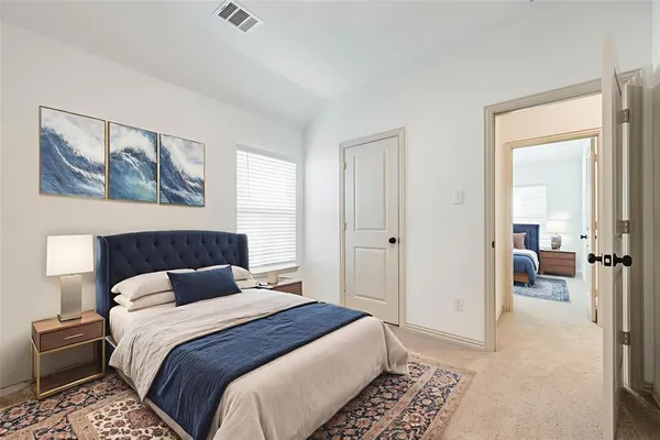 a bedroom with a bed and a walk in closet
