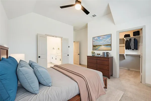 a bedroom with a bed and a painting on the wall