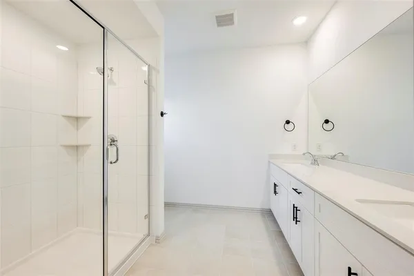 a bathroom with a granite countertop sink a mirror and a shower