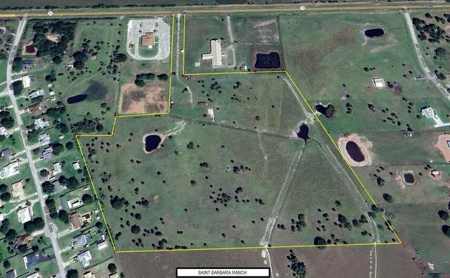 an aerial view of a residential apartment building with a yard