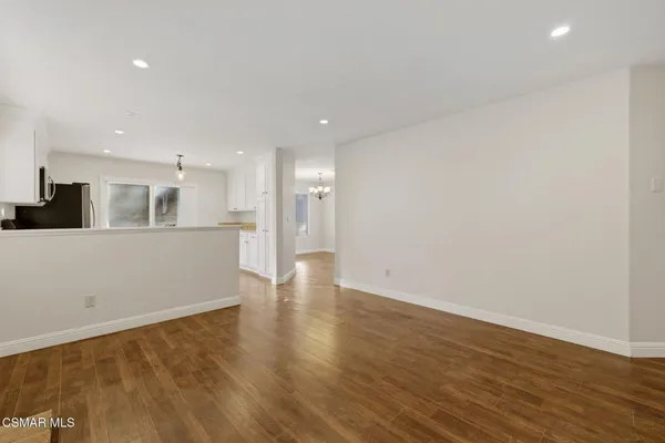 a view of kitchen with kitchen island and stainless steel appliances