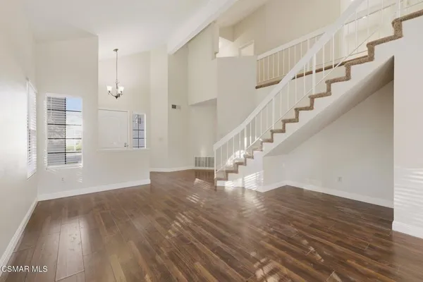 a view of entryway and hall with wooden floor