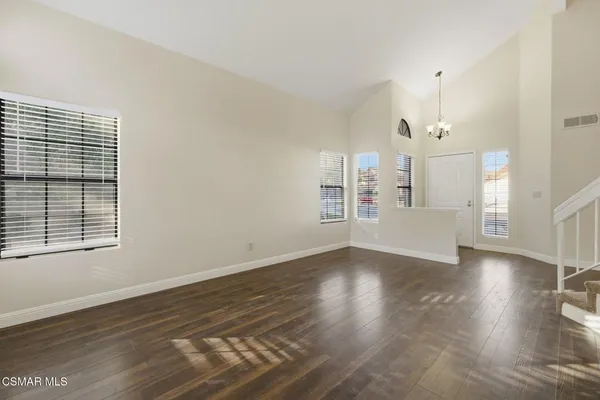 a view of a big room with wooden floor windows and fireplace