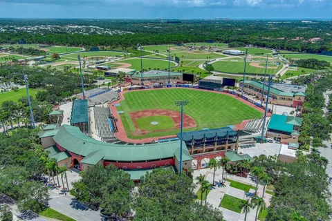 an aerial view of a house with a big yard