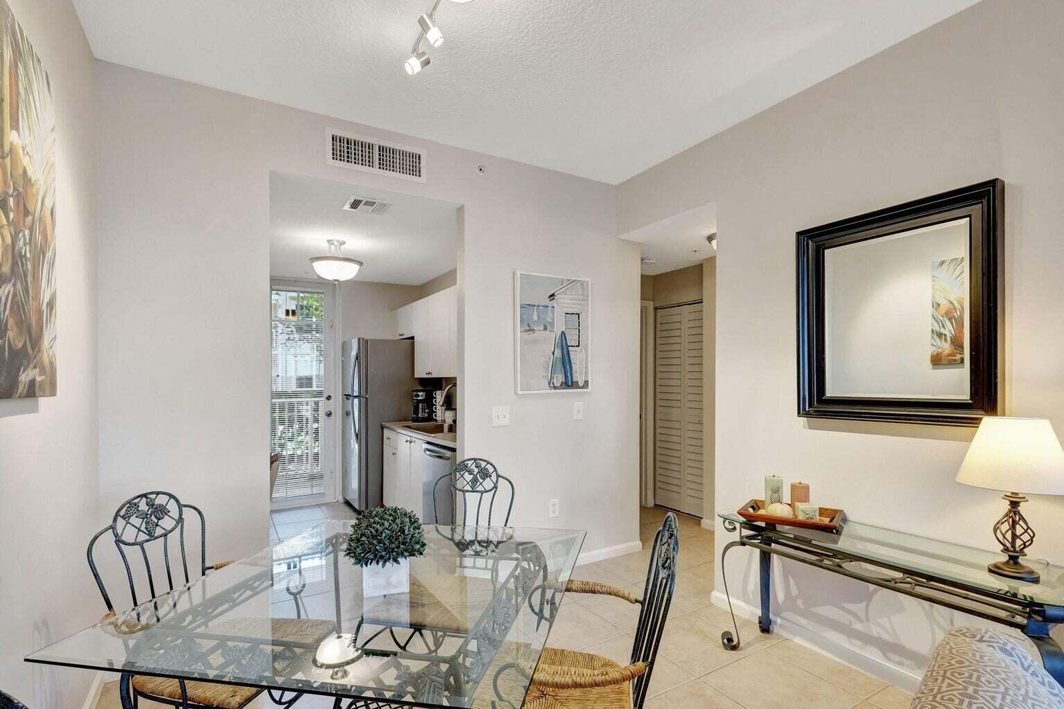 4736 Chancellor Drive, Unit 11 Jupiter, FL 33458 - Photo 7 of 35 a view of a dining room with furniture and a chandelier