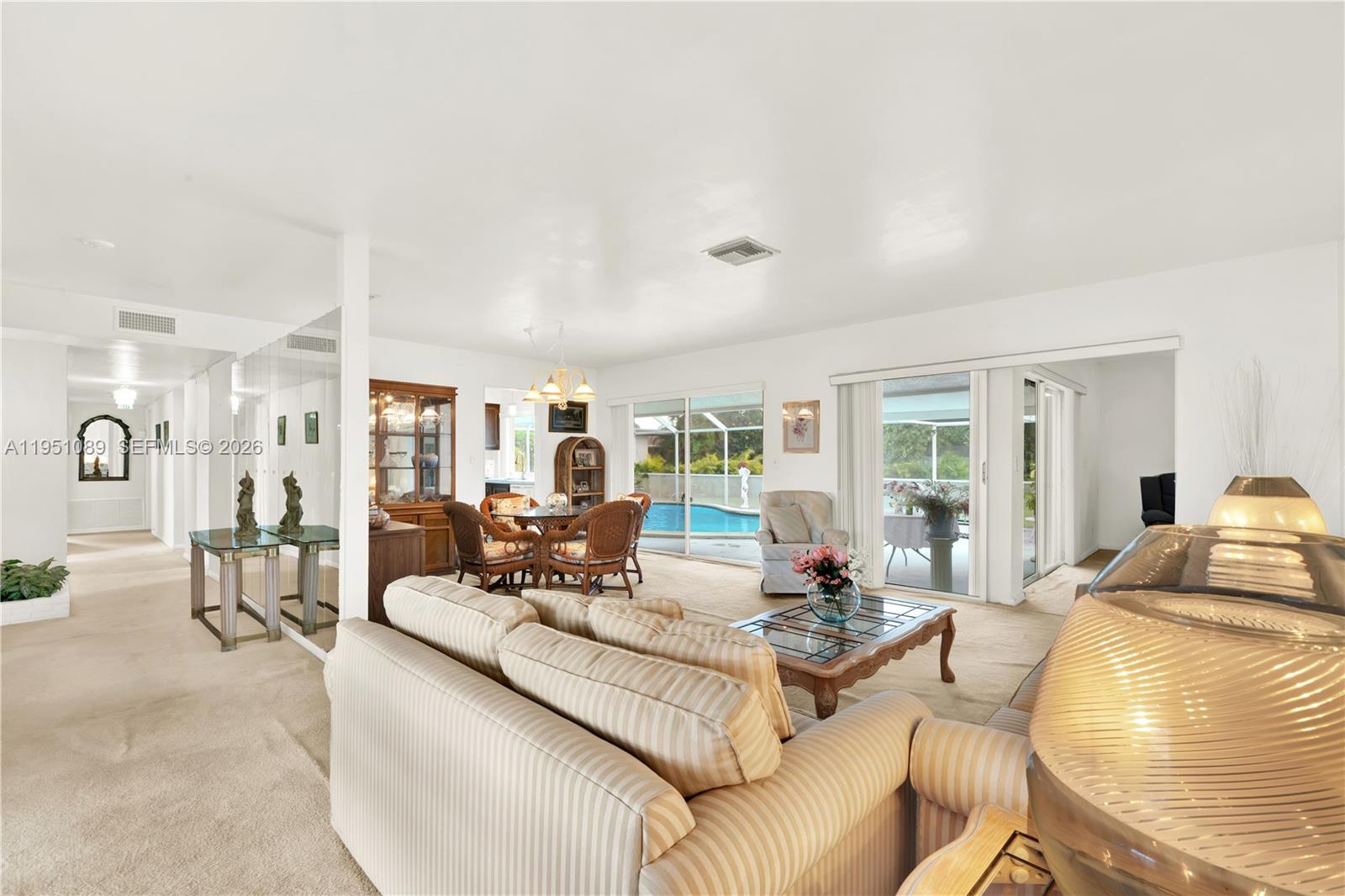 11260 Southwest 181st Terrace Miami, FL 33157 - Photo 11 of 57 a living room with furniture and a table