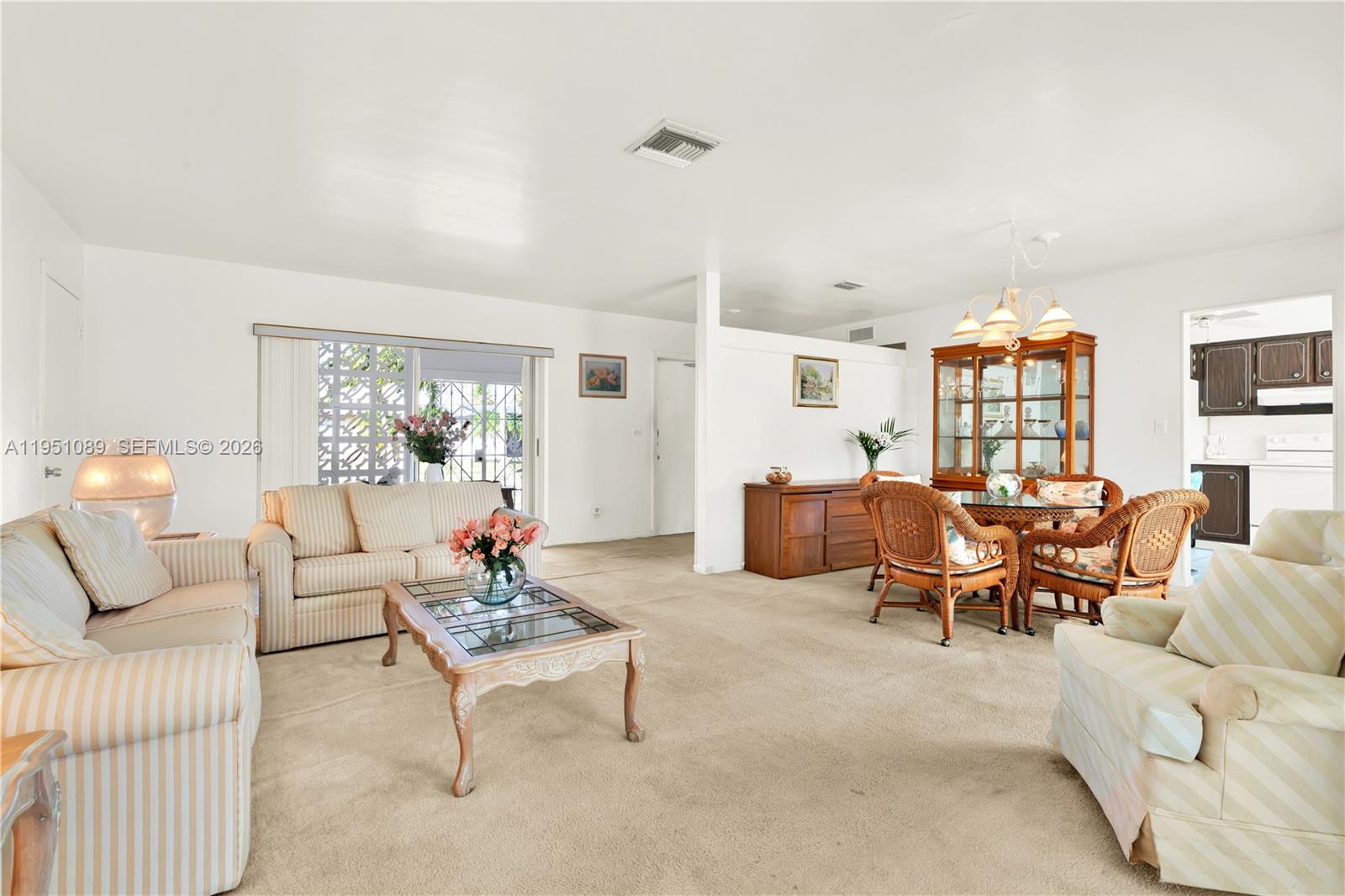 11260 Southwest 181st Terrace Miami, FL 33157 - Photo 13 of 57 a living room with furniture and a large window