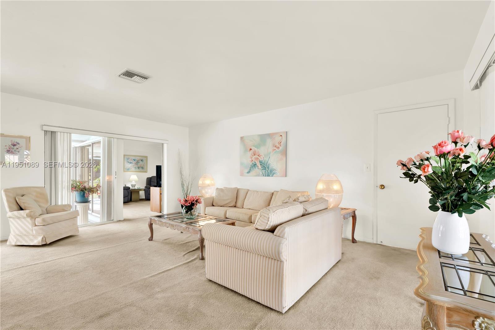 11260 Southwest 181st Terrace Miami, FL 33157 - Photo 19 of 57 a living room with furniture and flowers