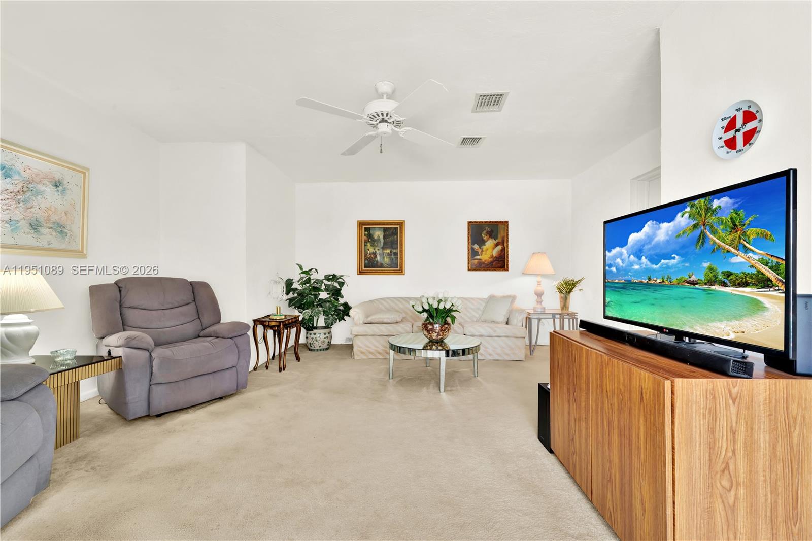 11260 Southwest 181st Terrace Miami, FL 33157 - Photo 20 of 57 a living room with furniture and a flat screen tv