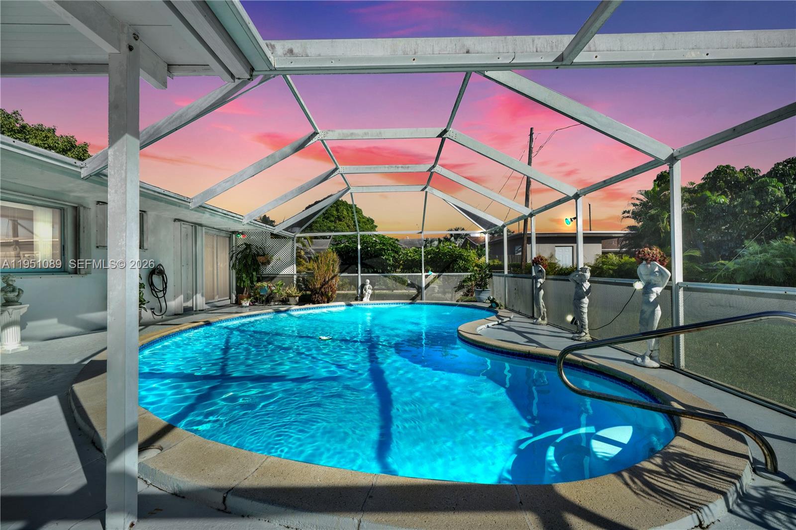 11260 Southwest 181st Terrace Miami, FL 33157 - Photo 2 of 57 a view of a backyard with table and chairs under an umbrella