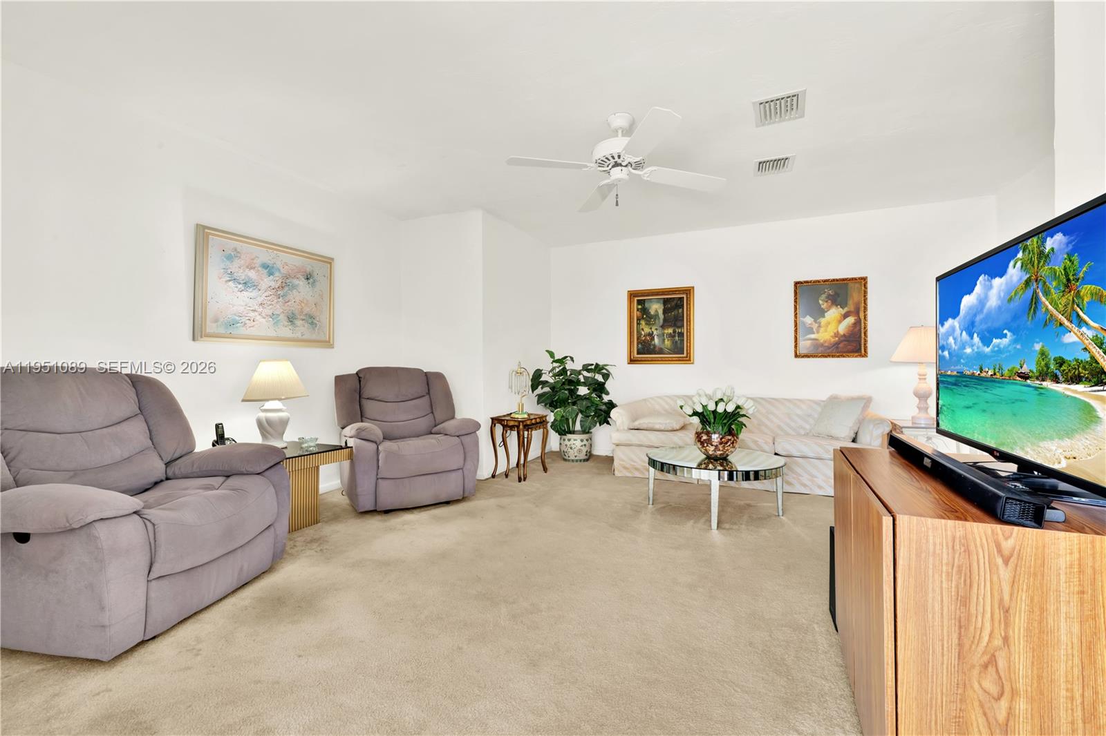 11260 Southwest 181st Terrace Miami, FL 33157 - Photo 21 of 57 a living room with furniture and a flat screen tv