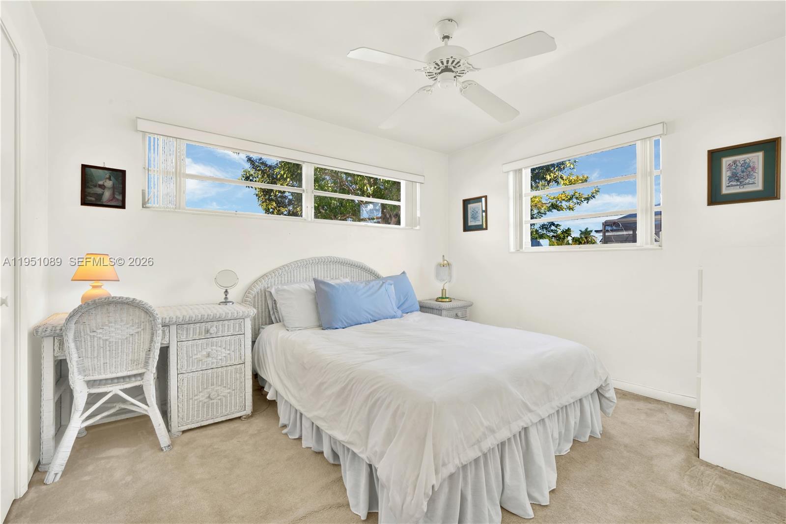11260 Southwest 181st Terrace Miami, FL 33157 - Photo 25 of 57 a bedroom with a bed and a chandelier