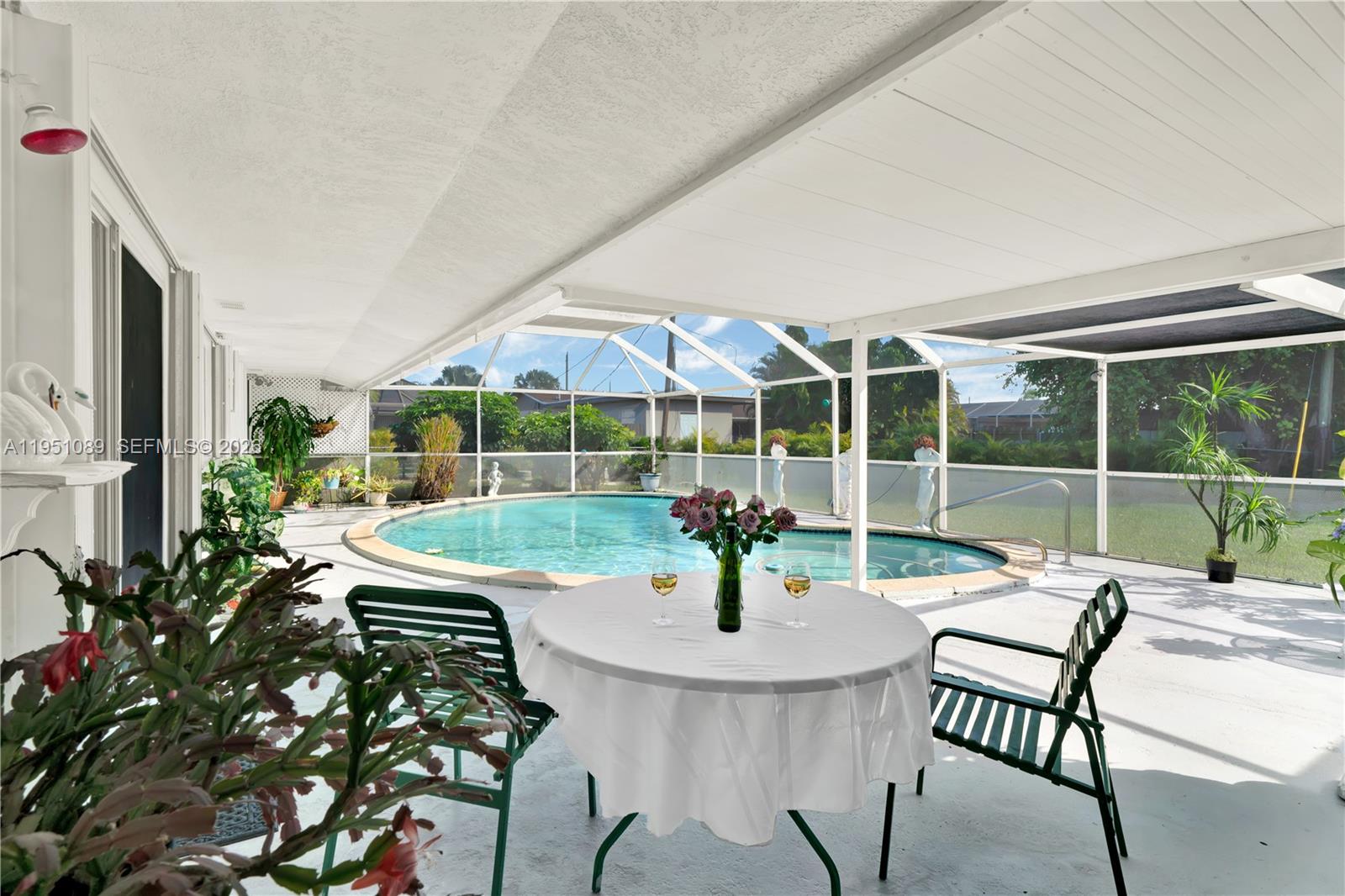 11260 Southwest 181st Terrace Miami, FL 33157 - Photo 29 of 57 a view of a patio with a table and chairs