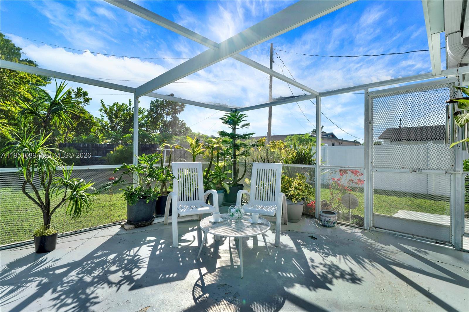 11260 Southwest 181st Terrace Miami, FL 33157 - Photo 30 of 57 a view of a patio with table and chairs potted plants