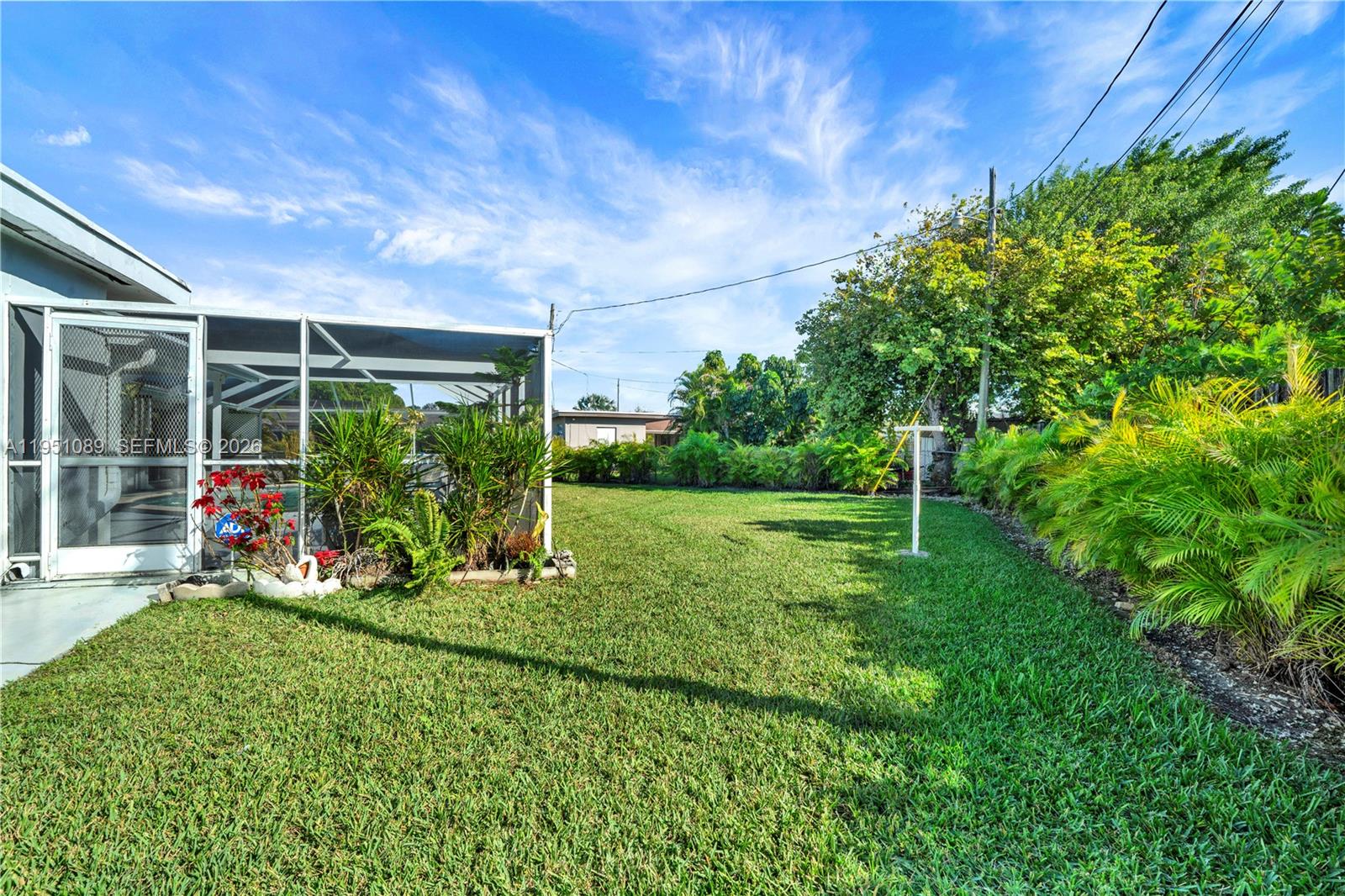 11260 Southwest 181st Terrace Miami, FL 33157 - Photo 44 of 57 a view of a garden with plants and large trees