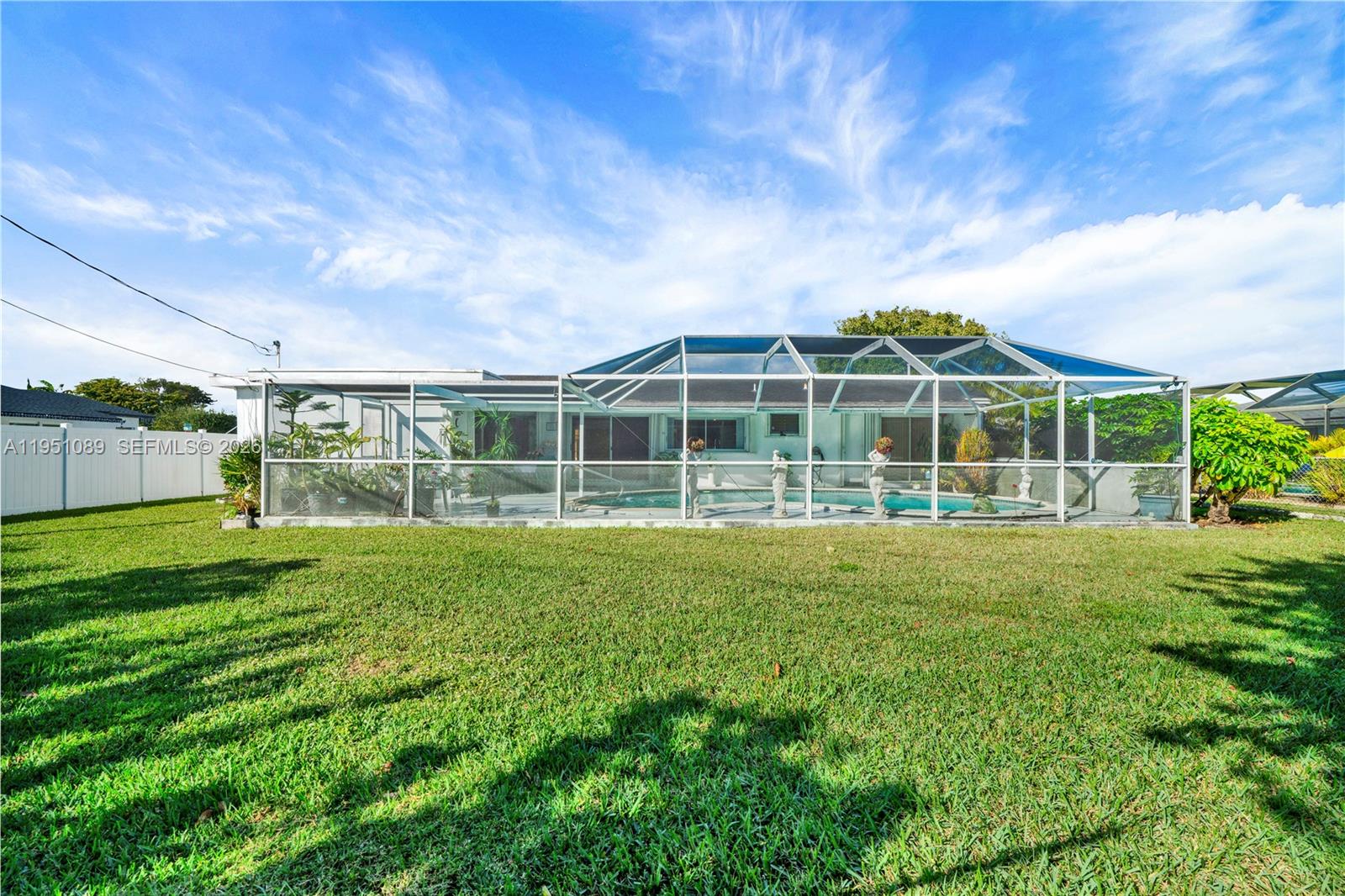 11260 Southwest 181st Terrace Miami, FL 33157 - Photo 45 of 57 a view of a house with a backyard and a garden