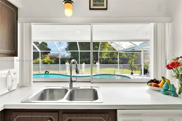 a view of a sink and table in a kitchen