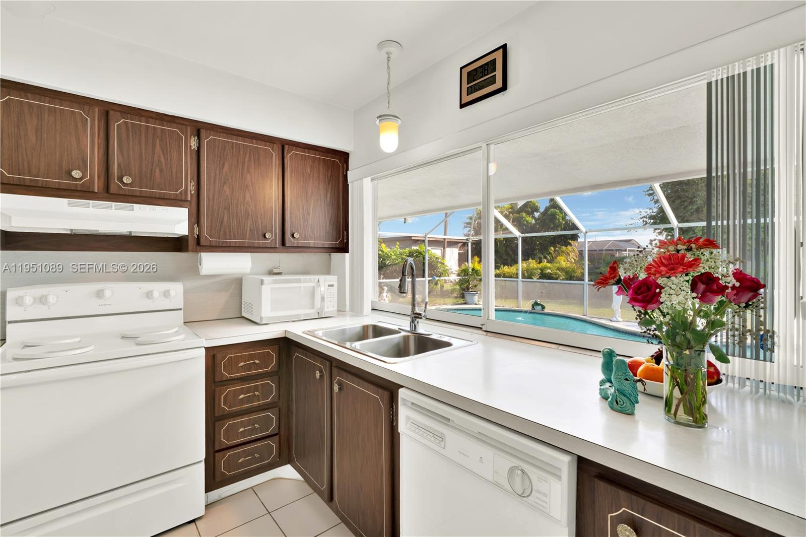 11260 Southwest 181st Terrace Miami, FL 33157 - Photo 7 of 57 a kitchen with a sink and cabinets