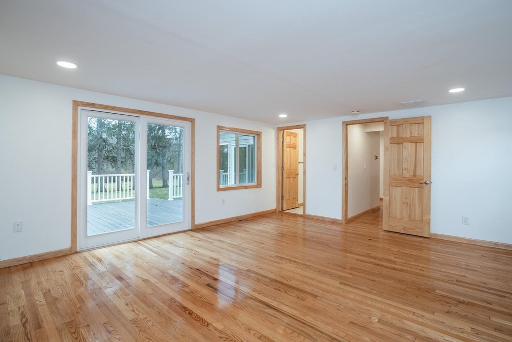 70 Leverett Road Amherst, MA 01002 - Photo 20 of 42 a view of an empty room with wooden floor and a window