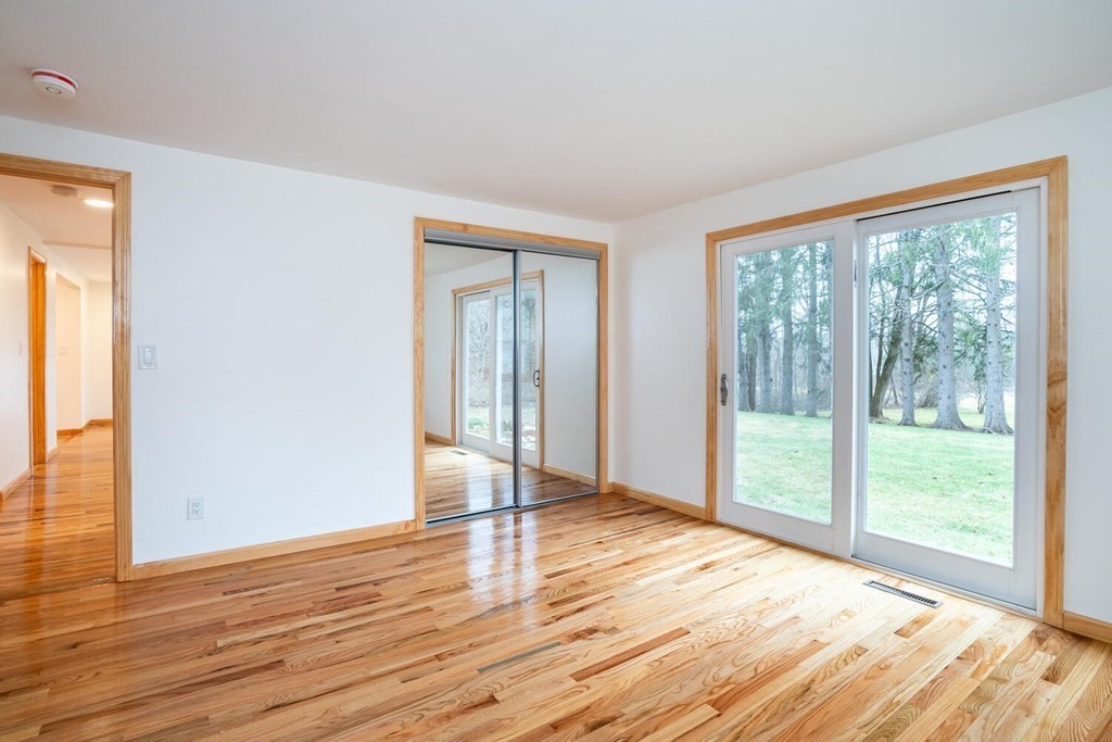 70 Leverett Road Amherst, MA 01002 - Photo 29 of 42 a view of an empty room with wooden floor and a window